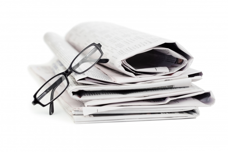 3625379-newspapers-and-black-glasses